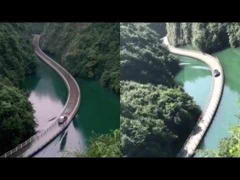 Amazing! Vehicle passes floating bridge with rising waves on river