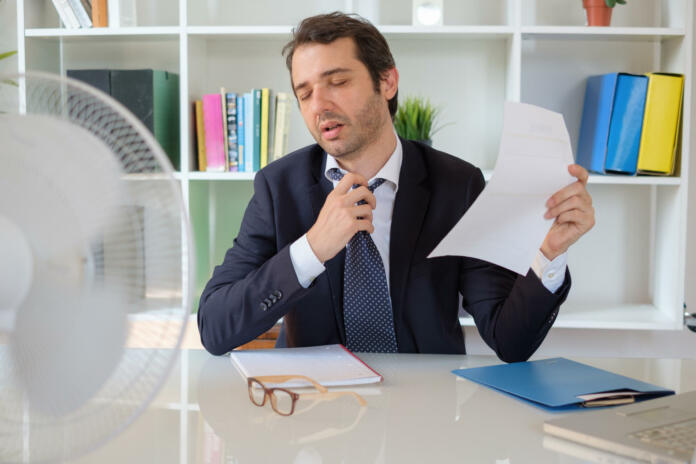 Office employee feeling stressed after summer heat haze