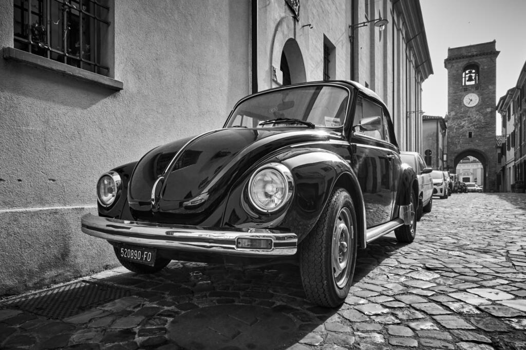 San Giovanni in Marignano, Italy - February 29, 2020: Vintage car Volkswagen Beetle 1303 Cabriolet (1972â1980) parked in the street in old italian town. Black and white photography