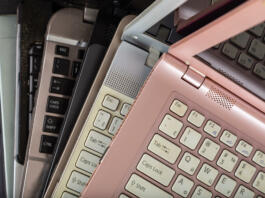 Stack of used laptops in different colors and models. Tha notebooks for repair and service.