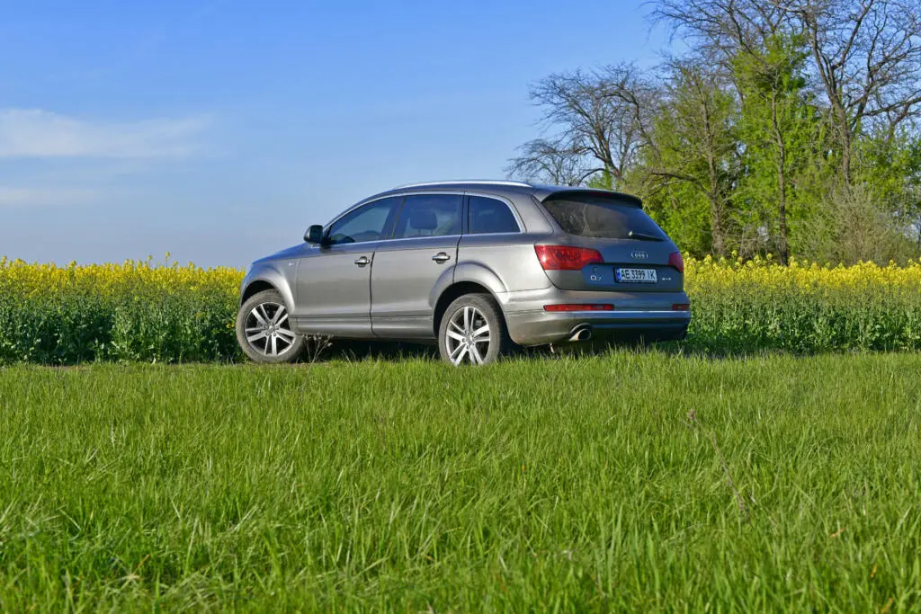 Ukraine, Novomoskovsk city . Audi Q7 SUV in the spring against the backdrop of a rapeseed field.