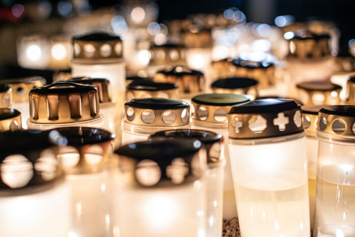 Grave candles on a cemetery on all saints eve.