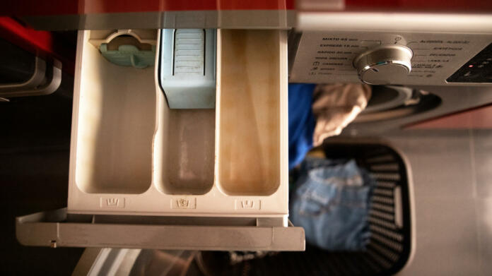 open drawer to pour the washing machine detergent