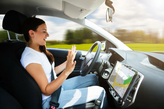 side-view-of-a-young-woman-sitting-in-self-driving-modern-car-stockpack-istock Side View Of A Young Woman Sitting In Self Driving Modern Car
