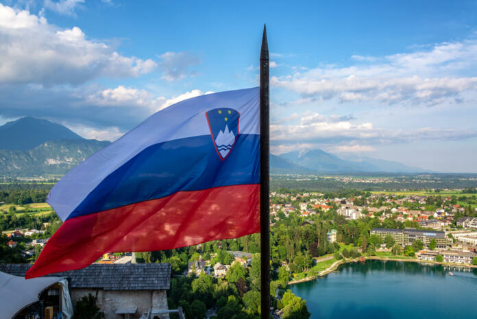 Slovenian flag flying high over Lake Bled in Slovenia