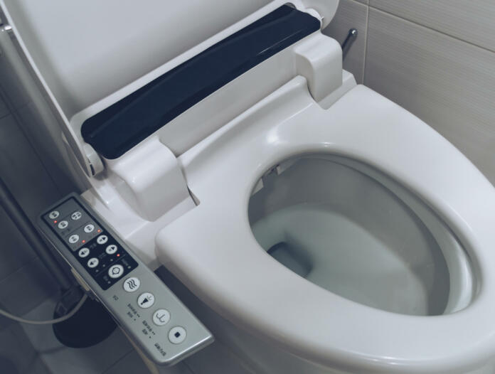 close up view of smart toilet seating with washing, cleaning, drying functions and ability to use it for child and women
