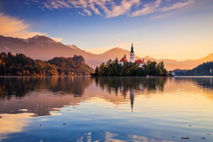 Lake Bled, Slovenia. Sunrise at Lake Bled with famous Bled Island and historic Bled Castle in the background.