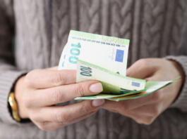 One hundred euro banknotes in female hands. Savings in European countries concept