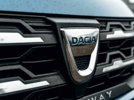 Zagreb, Croatia – December 30, 2021: A black and chrome trim around Dacia logo on front of silver car