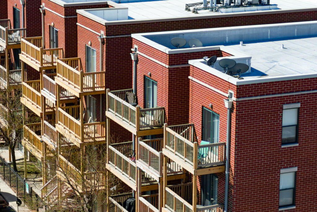 Multiple wooden balconies on the back of brick urban residences in the Lincoln Park neighborhood of Chicago