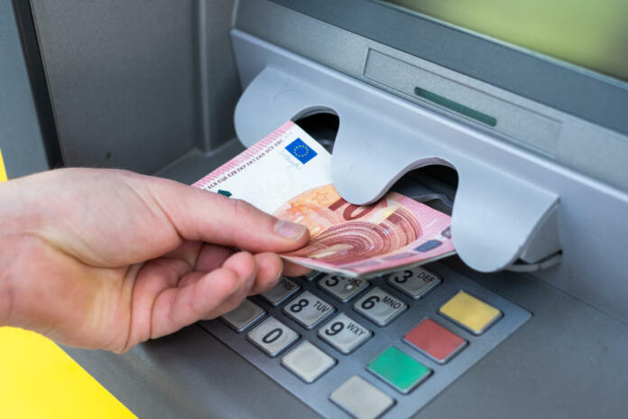 Bank and people concept with close up of hands choosing option on atm machine