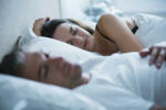 Serene couple sleeping in bed