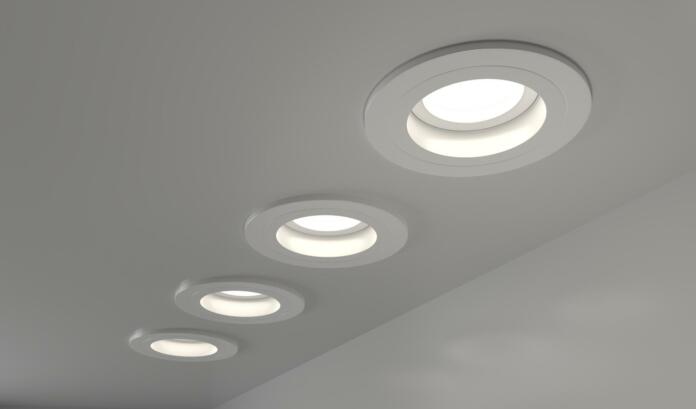 Spotlights recessed ceiling 3D render. Realistic interior room with round glowing downlights at night. Artificial lighting, LED lamps for home or office on dark background angle view, 3D illustration