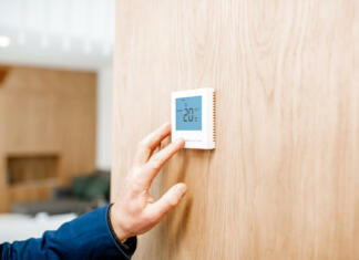 Idealna sobna temperatura? Preverili smo kakšna mora biti v posameznih prostorih Adjusting room temperature with electronic thermostat at home, close-up view with no face