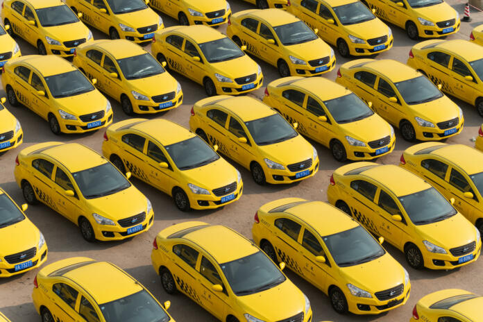Chongqing, China-May  2, 2021: Chinese electricity car industry  booming and new electricity cars are decorated for taxi in parking lot.