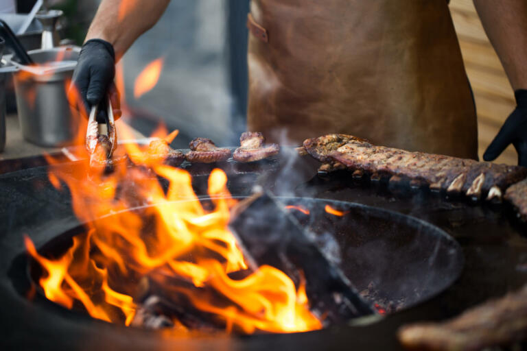 Grilled pork baby ribs with barbecue sauce on the grill. Festival street food