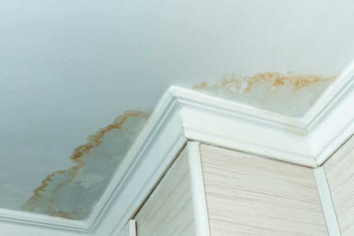 Neighbors have a water leak, water-damaged ceiling, close-up of a stain on the ceiling.