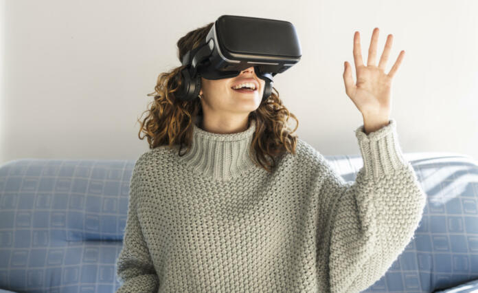 woman using vr glasses at home