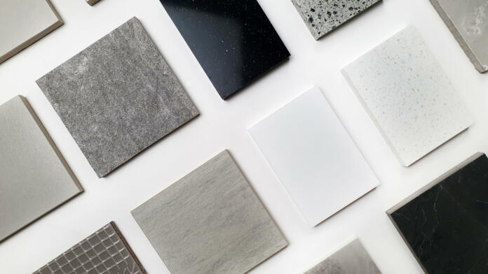 samples of interior stone material consists concrete tiles, quartz stones, artificial stones, graphic tile. top view of interior selected material for mood and tone board. inteior materials palette.