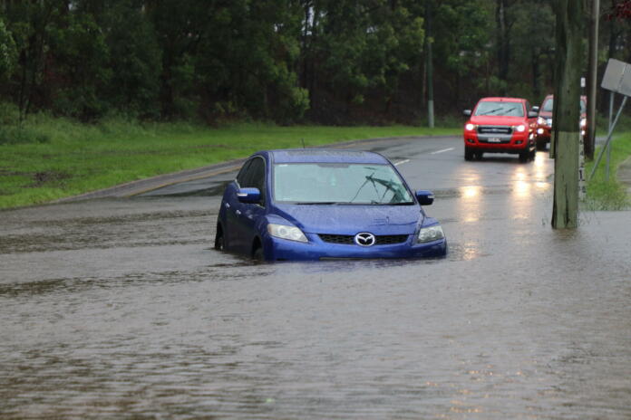 BRISBANE, AUSTRALIA - March 30, 2017: Car stuck in floodwater in the suburb of Rocklea from huge rainfall as a result of Tropical Cyclone Debbie.