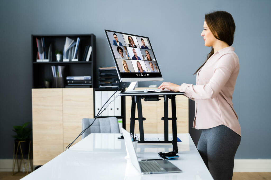 Adjustable Height Desk Stand In Office Using Computer