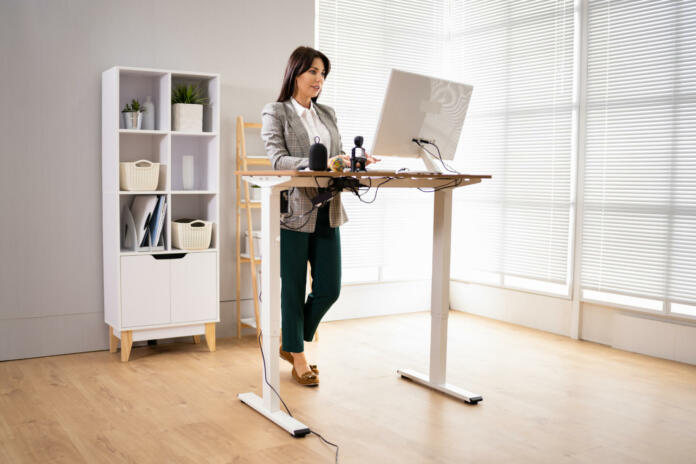 Adjustable Height Desk Stand In Office Using Computer