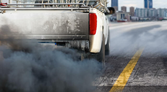 air pollution crisis in city from diesel vehicle exhaust pipe on road