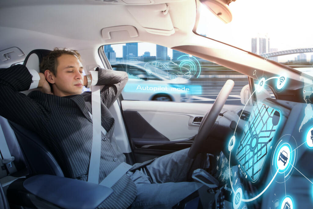 Caucasian man sleeping in autonomous car. Self driving vehicle.