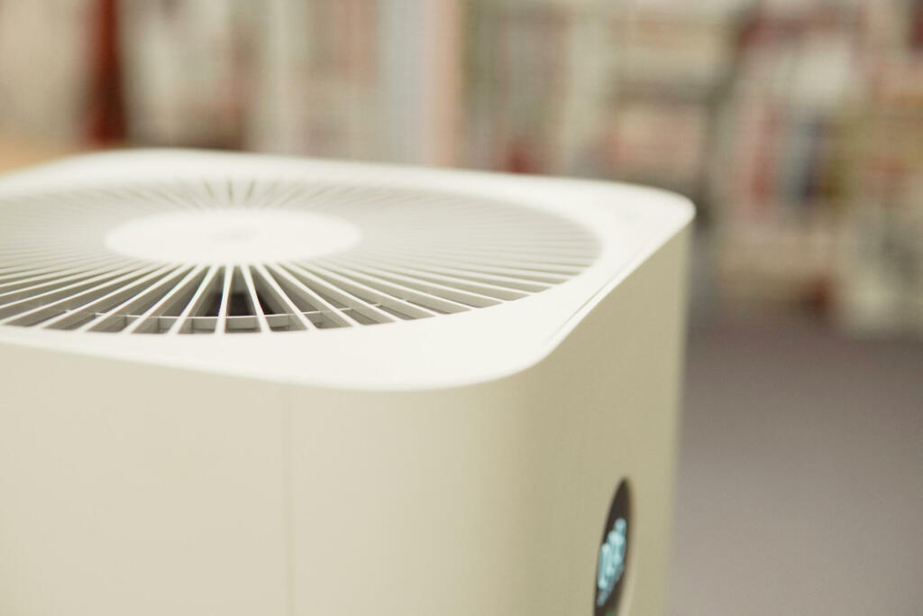 Closeup DOF of indoor air purifier in bedroom, air pollution PM 2.5, air quality, respiratory health concept