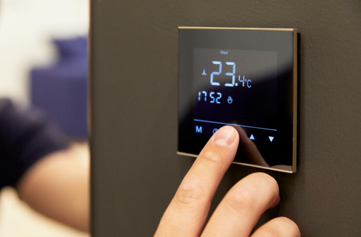 electronic floor heating setting, on the touch screen, hand pressing