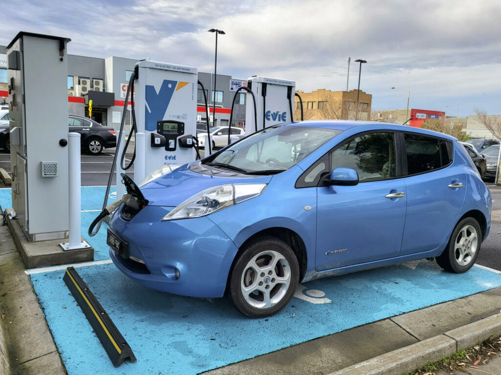 Melbourne, Australia: July 16, 2022: Zero emmissions Nissan LEAF car recharging at an EVIE charging station. EVIE Smart Home Charge point has been designed to provide the user with the perfect charging solution for the home & commercial space.