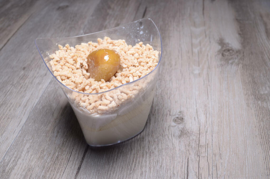 a cup of Panna cotta of chestnut with wood background