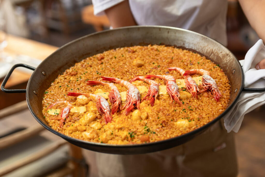 Traditional spanish seafood paella with shrimps in the fry pan