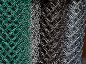 Large rolls of metal mesh for fencing.