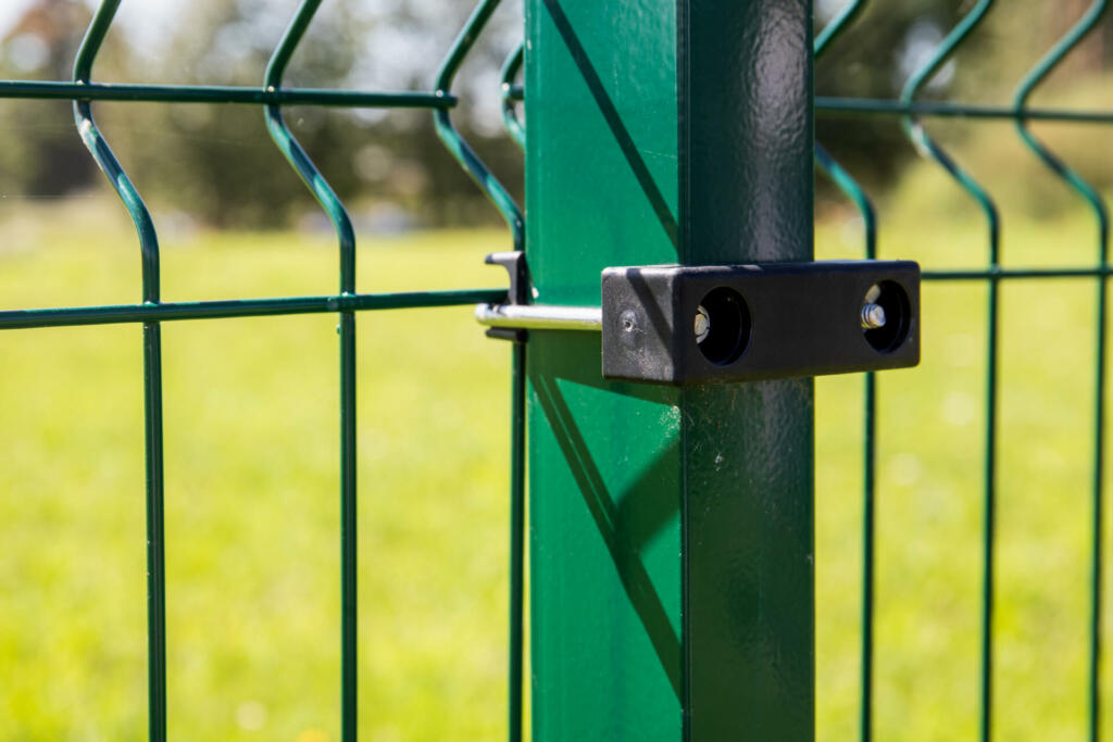 Panel fence. Green pole, construction and landscaping.