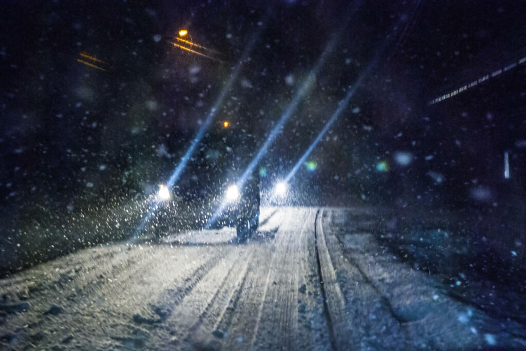 Car driving during winter snowstorm. Motion blur.