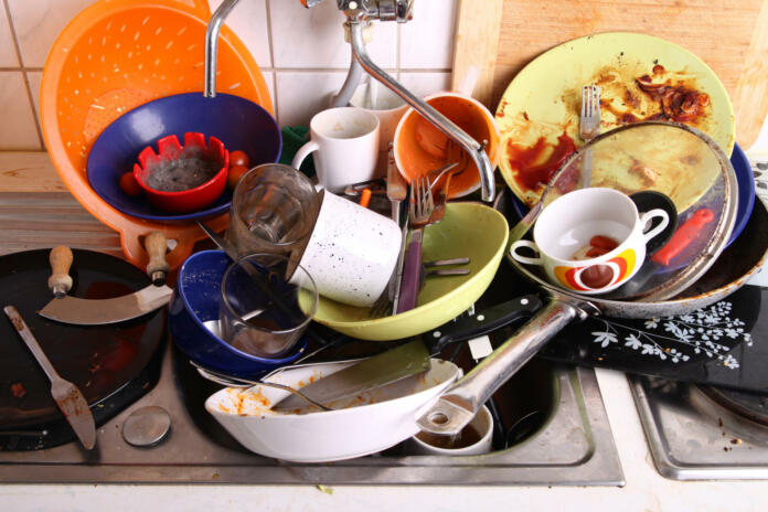 huge heap of dirty disgusting dishes in the sink waiting to be washed by unreliable flatmate