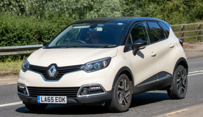 Milton Keynes,UK - July 7th 2023:   2016 cream diesel RENAULT CAPTUR car travelling on a UK road