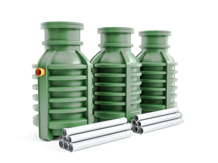 3d rendering of three green household septic tanks on white background