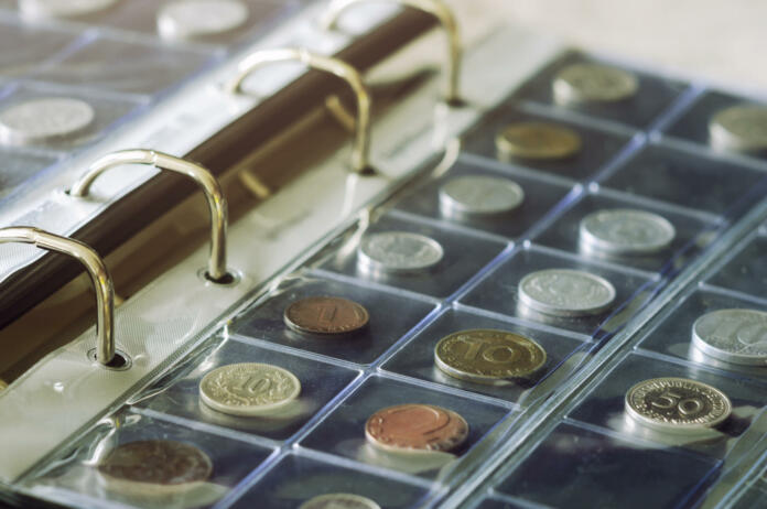 Close-up view of coins holding in blisters in coin album. Numismatics