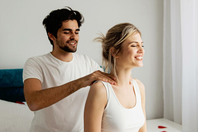 Man giving a head massage to his girlfriend