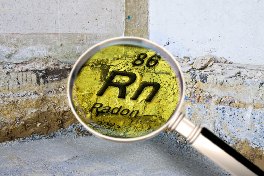 Preparatory stage for the construction of a ventilated crawl space in an old brick building - Searching gas radon concept image seen through a magnifying glass.