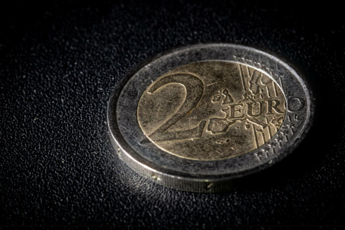 Two euro coin on dark textured background. Close-up macro photography, high angle top view