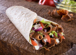 Hamburger, kebab, pomfrit… Katera hitra prehrana je najmanjše zlo? A delicious doner donair kebab wrap with spicy meat, lettuce, tomato, red onion and sauce.