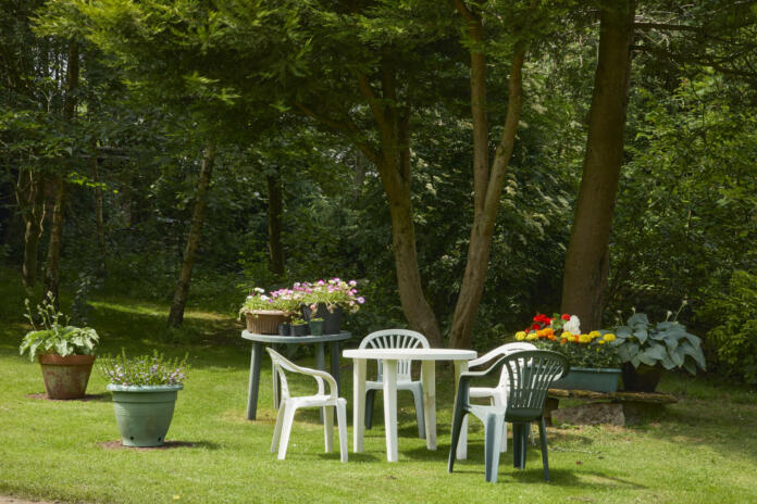 A sunny June day, and plastic garden furniture laid out on a lawn in the moorland smallholding garden at 900ft. North Yorkshire