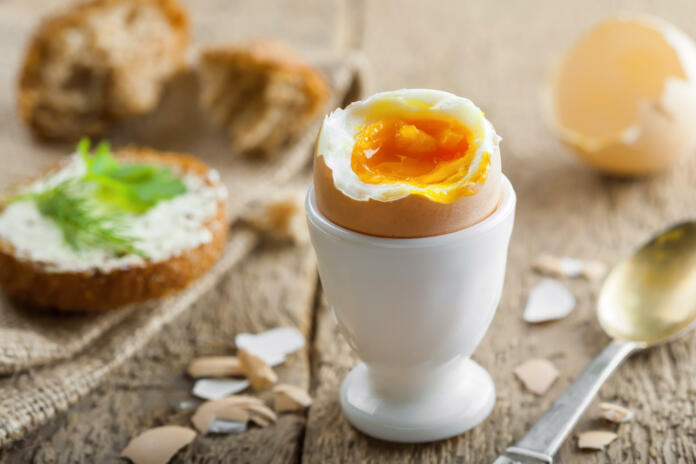 Perfect soft boiled egg with bread and butter for breakfast. Traditional healthy food.