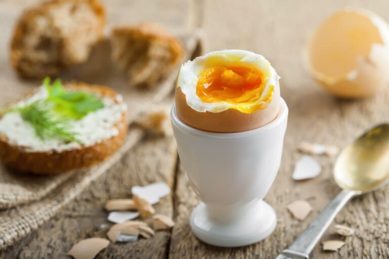 Perfect soft boiled egg with bread and butter for breakfast. Traditional healthy food.