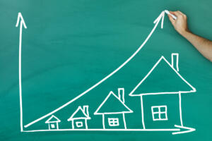 House prices growth concept on green blackboard