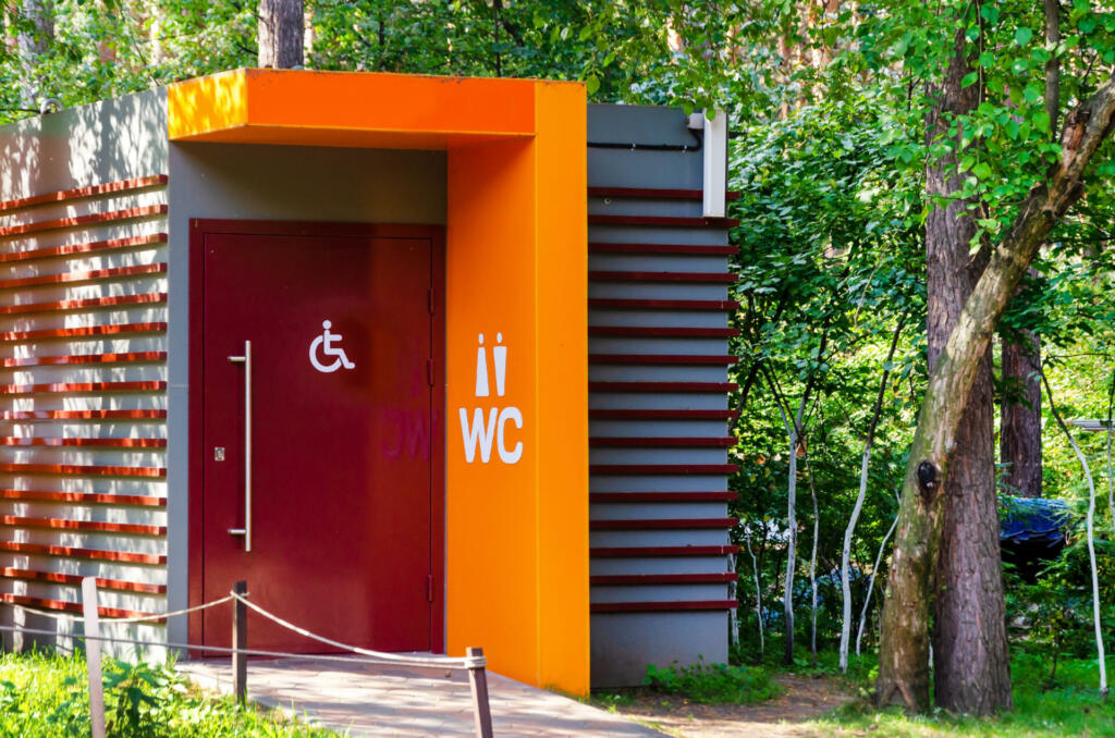 Modern public toilet in the city park. Toilet with icons: disabled person, female, male. toilet sign, WC