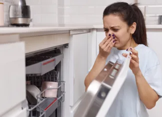 Ali posodo pravilno zlagate v pomivalni stroj? Teh 9 napak pravi drugače! woman smells strange and terrible smell coming from dishwasher machine in kitchen